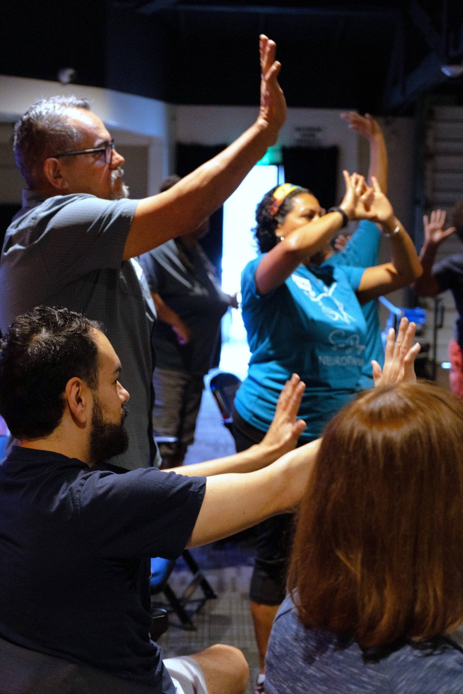 Standing and seated participants dance together.